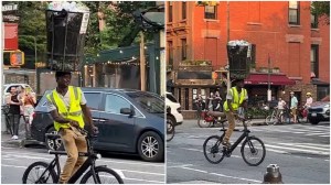 Man Balance Trash Can on Head While Riding Bicycle