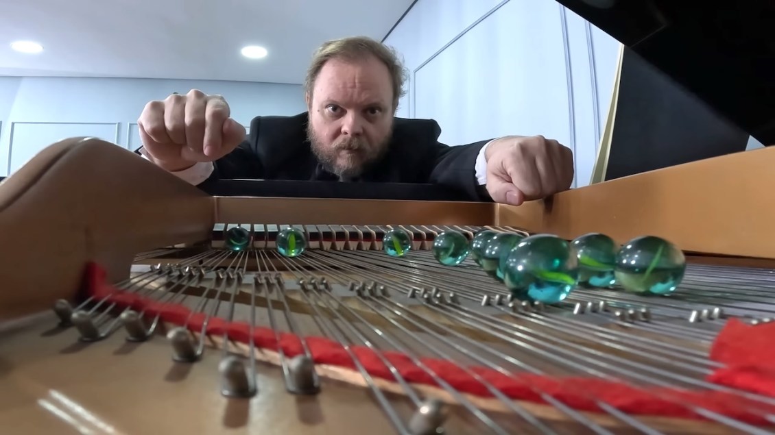 Playing a Grand Piano With Marbles on the Strings