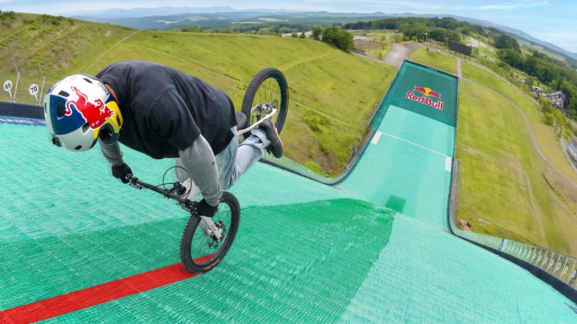 Trials Bike Rider Sets Two World Records by Riding Backward on One Wheel Down a Steep Ski Slope