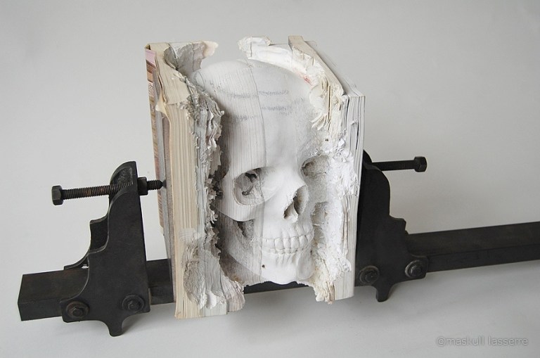 Incarnate, a Human Skull Carved Into Old Software Manuals by Maskull Lasserre